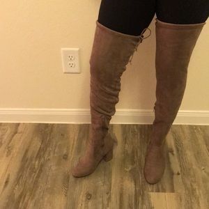 Taupe half zip tie top knee high boots.